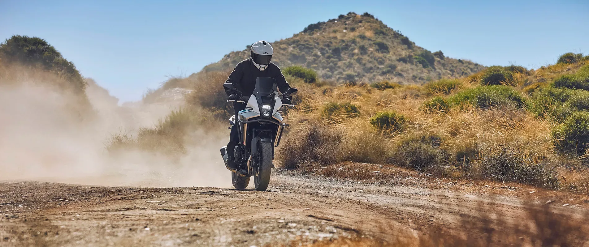 Honda NX500 E-Clutch riding on a gravel road